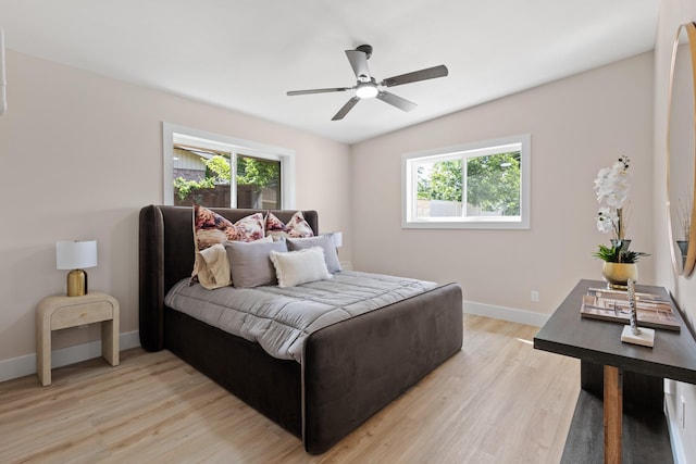 10528 Swallow Ln, Dallas, TX 75218 - bedroom featuring light wood-style flooring, baseboards, and ceiling fan