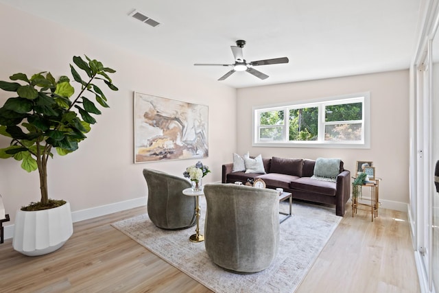 10528 Swallow Ln, Dallas, TX 75218 - living room featuring light wood-style floors, a ceiling fan, and baseboards