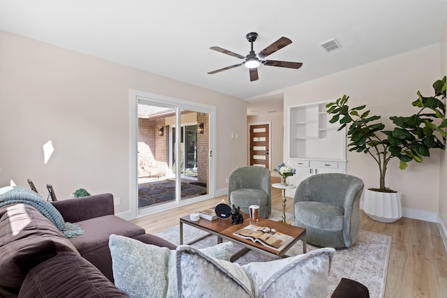 10528 Swallow Ln, Dallas, TX 75218 - living room with ceiling fan, light wood-style floors, and baseboards