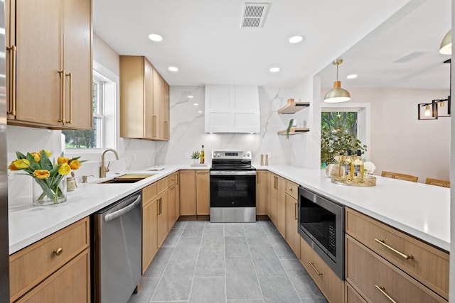 10528 Swallow Ln, Dallas, TX 75218 - kitchen featuring stainless steel appliances, a peninsula, a sink, light brown cabinetry, and open shelves
