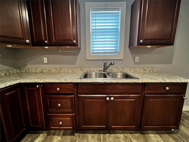 106 Lane St, Comanche, TX 76442 - kitchen featuring a sink, wood finished floors, and dark brown cabinetry