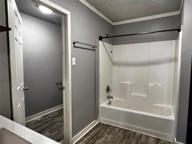 106 Lane St, Comanche, TX 76442 - full bathroom with ornamental molding, wood finished floors, a textured ceiling, shower / bath combination, and baseboards