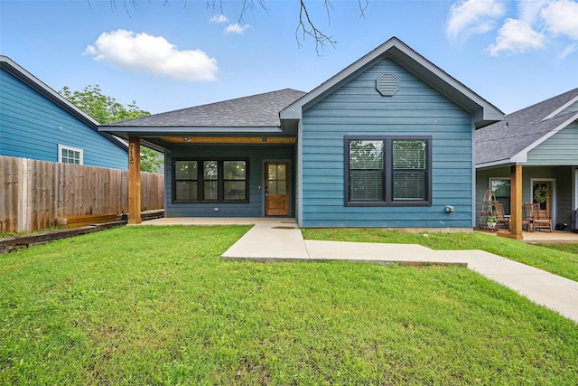 713 E Texas St, Denison, TX 75021 - back of house featuring roof with shingles and a patio