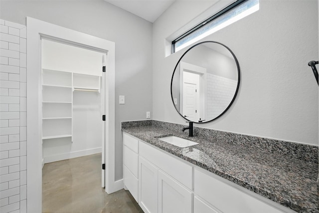 713 E Texas St, Denison, TX 75021 - full bathroom with vanity, concrete flooring, and baseboards