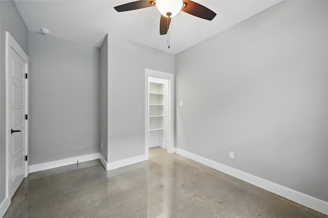 713 E Texas St, Denison, TX 75021 - unfurnished bedroom with finished concrete flooring, baseboards, ceiling fan, and a closet