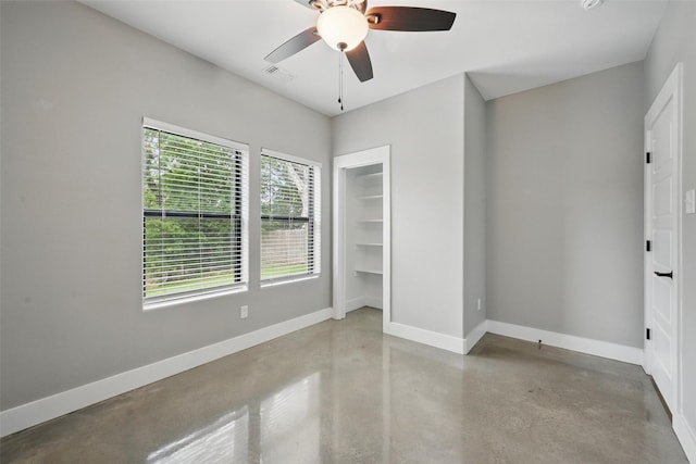 713 E Texas St, Denison, TX 75021 - unfurnished bedroom featuring concrete flooring, baseboards, ceiling fan, and a closet