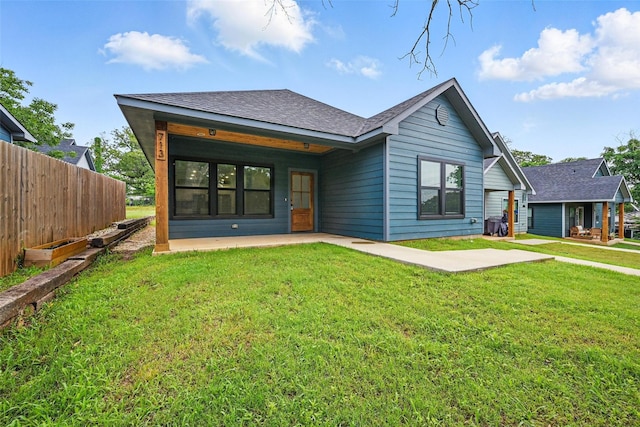713 E Texas St, Denison, TX 75021 - rear view of house with a patio and a shingled roof