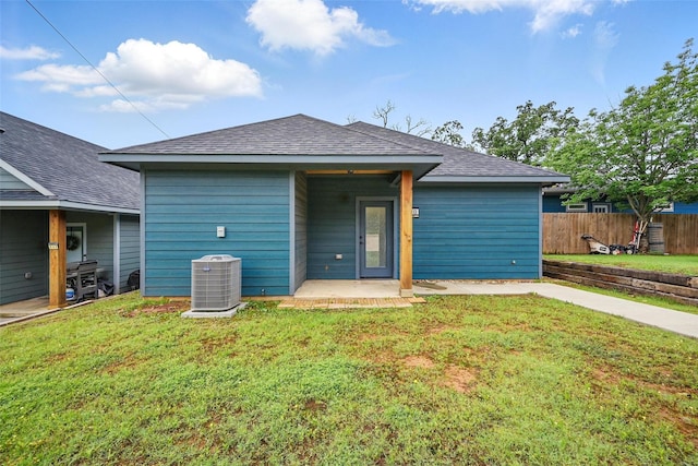 713 E Texas St, Denison, TX 75021 - back of property featuring central AC unit, a shingled roof, and a patio area