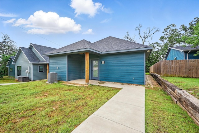 713 E Texas St, Denison, TX 75021 - view of front of house with roof with shingles, a patio area, and cooling unit