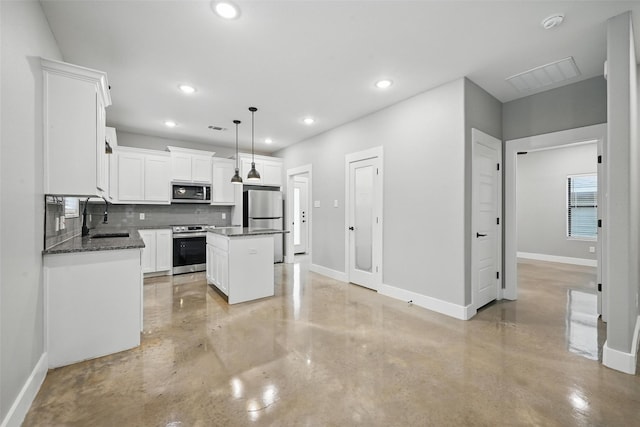 713 E Texas St, Denison, TX 75021 - kitchen with stainless steel appliances, finished concrete floors, a sink, baseboards, and recessed lighting