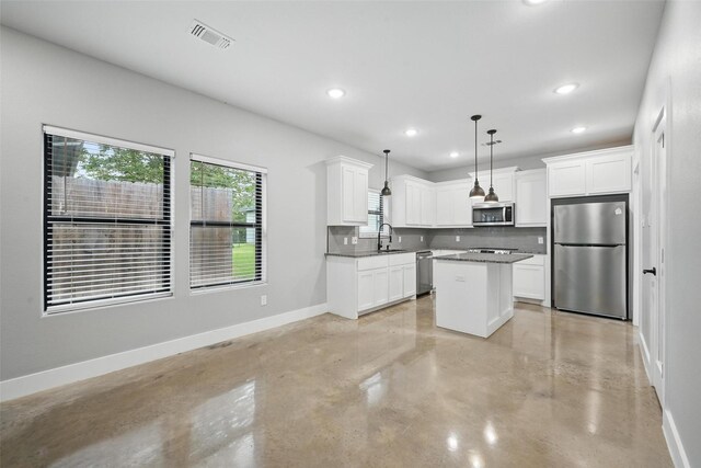 713 E Texas St, Denison, TX 75021 - kitchen with appliances with stainless steel finishes, finished concrete floors, baseboards, recessed lighting, and backsplash