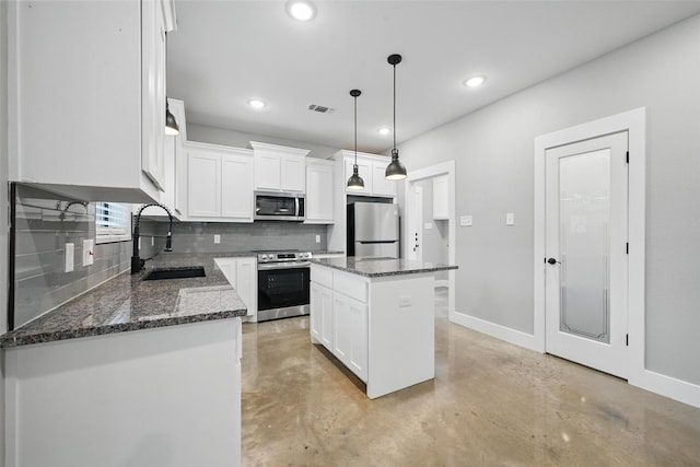 713 E Texas St, Denison, TX 75021 - kitchen featuring appliances with stainless steel finishes, a sink, backsplash, finished concrete flooring, and baseboards