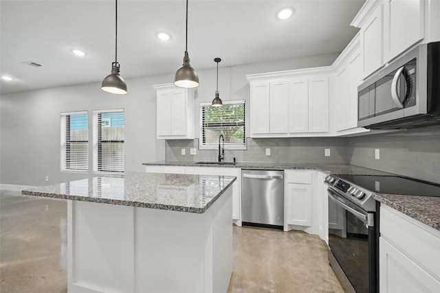 713 E Texas St, Denison, TX 75021 - kitchen with appliances with stainless steel finishes, finished concrete floors, a sink, backsplash, and recessed lighting