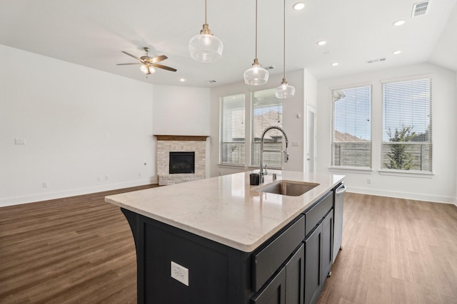 2208 13th St, Argyle, TX 76226 - kitchen featuring a sink, wood finished floors, a fireplace, baseboards, and recessed lighting