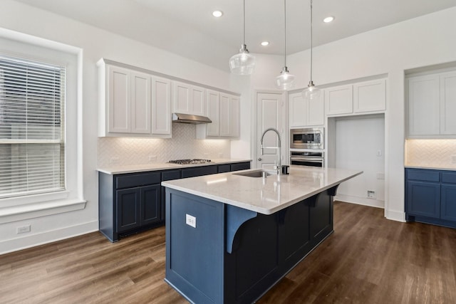 2208 13th St, Argyle, TX 76226 - kitchen with a sink, stainless steel appliances, backsplash, hanging light fixtures, and dark wood finished floors