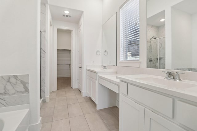 2208 13th St, Argyle, TX 76226 - full bath featuring a shower stall, vanity, tile patterned flooring, a bath, and a walk in closet