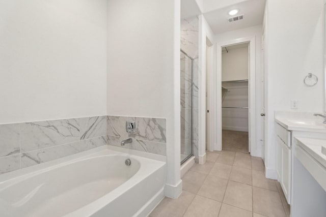 2208 13th St, Argyle, TX 76226 - bathroom featuring a garden tub, vanity, a spacious closet, a shower stall, and tile patterned flooring