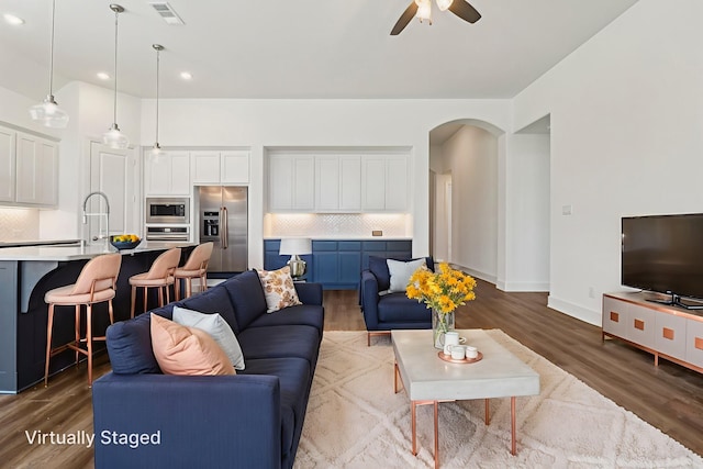 2208 13th St, Argyle, TX 76226 - living area featuring a ceiling fan, arched walkways, wood finished floors, recessed lighting, and baseboards