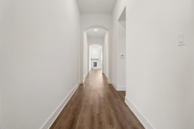 2208 13th St, Argyle, TX 76226 - corridor featuring arched walkways, dark wood-style flooring, and baseboards