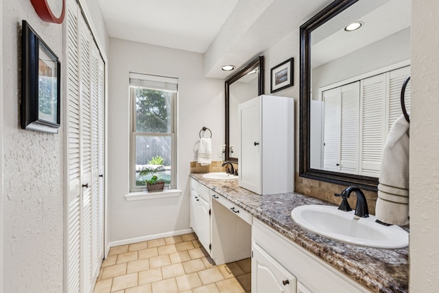 4008 Lynbrook Ln, Arlington, TX 76015 - full bathroom with a closet, double vanity, recessed lighting, baseboards, and tile patterned floors