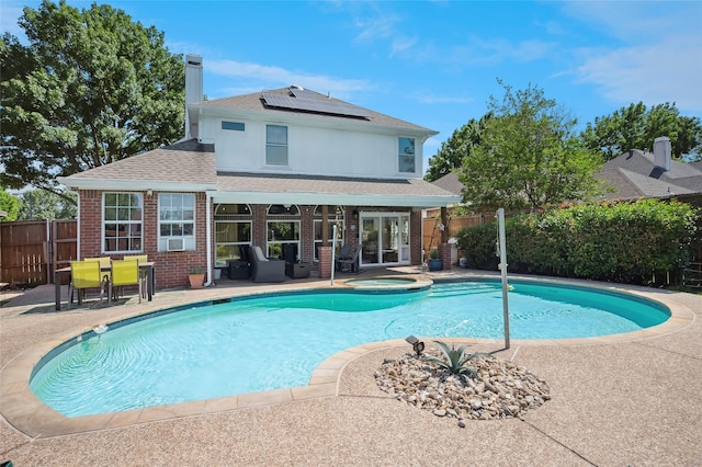 2201 Heatherton Pl, Plano, TX 75023 - view of swimming pool featuring a patio, a fenced backyard, french doors, a pool with connected hot tub, and an outdoor hangout area