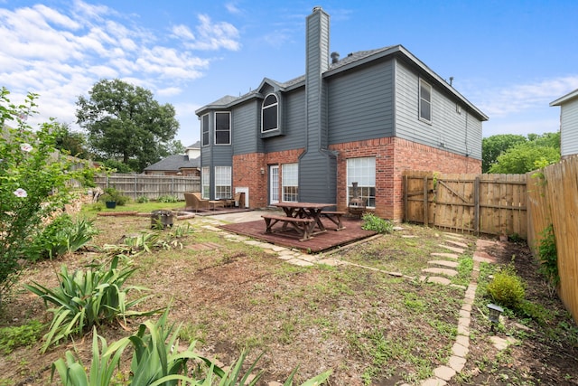 12809 Conifer Ln, Fort Worth, TX 76040 - rear view of property with brick siding, a fenced backyard, and a chimney