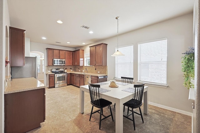 7009 Bishop Pine Rd, Denton, TX 76208 - dining room featuring baseboards, recessed lighting, and arched walkways