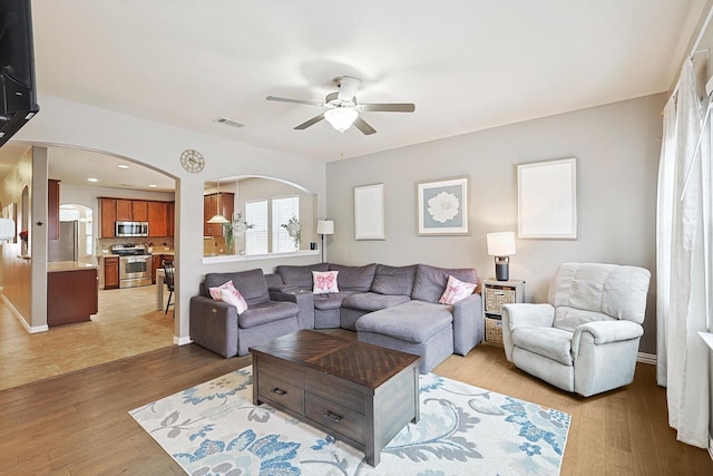 7009 Bishop Pine Rd, Denton, TX 76208 - living room with ceiling fan, arched walkways, wood finished floors, and baseboards