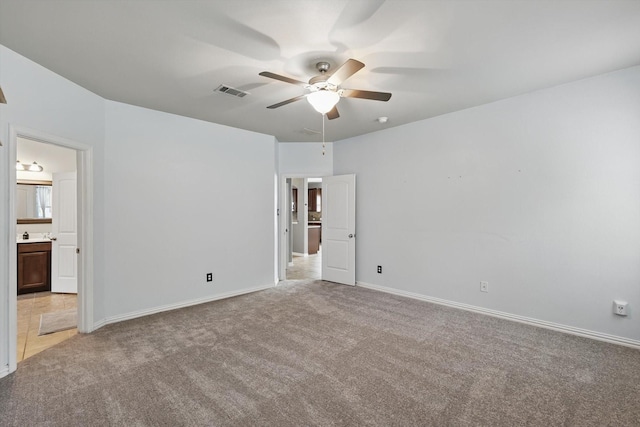 7009 Bishop Pine Rd, Denton, TX 76208 - unfurnished bedroom featuring light colored carpet, baseboards, ensuite bathroom, and a ceiling fan