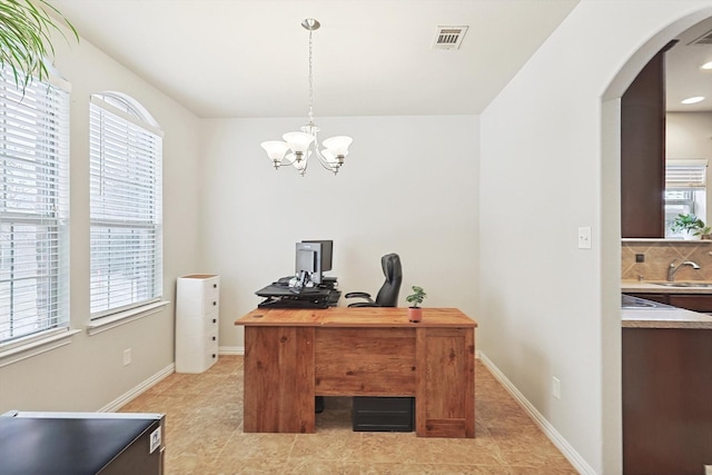7009 Bishop Pine Rd, Denton, TX 76208 - office area featuring arched walkways, light tile patterned floors, a chandelier, a sink, and baseboards