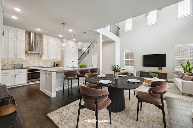 2070 White Grove Dr, Dallas, TX 75228 - dining area featuring healthy amount of natural light, dark wood-style flooring, stairs, recessed lighting, and baseboards