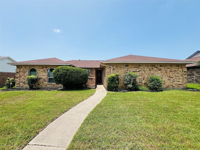 1013 Gannon Dr, Plano, TX 75025 - ranch-style home with a front lawn, brick siding, and a shingled roof