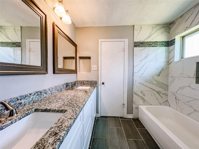 1013 Gannon Dr, Plano, TX 75025 - bathroom with a textured ceiling, double vanity, and tub / shower combination