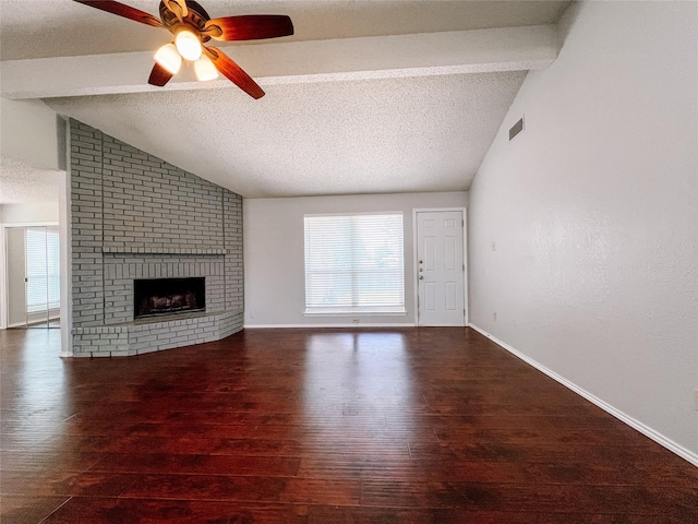 1013 Gannon Dr, Plano, TX 75025 - unfurnished living room featuring hardwood / wood-style flooring, a ceiling fan, a brick fireplace, baseboards, and a textured ceiling