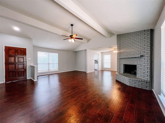 1013 Gannon Dr, Plano, TX 75025 - unfurnished living room featuring a ceiling fan, wood finished floors, a fireplace, and a textured ceiling