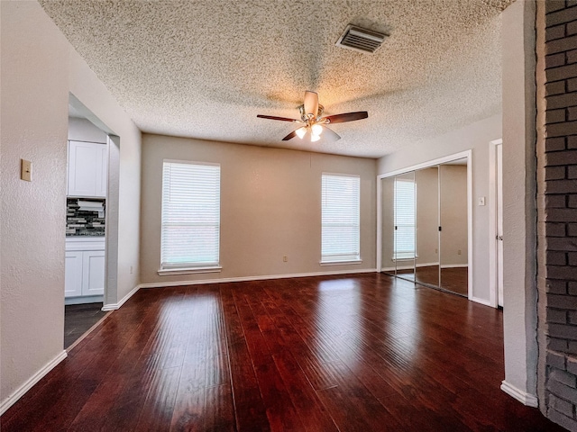 1013 Gannon Dr, Plano, TX 75025 - unfurnished living room featuring a ceiling fan, wood-type flooring, a textured ceiling, and baseboards