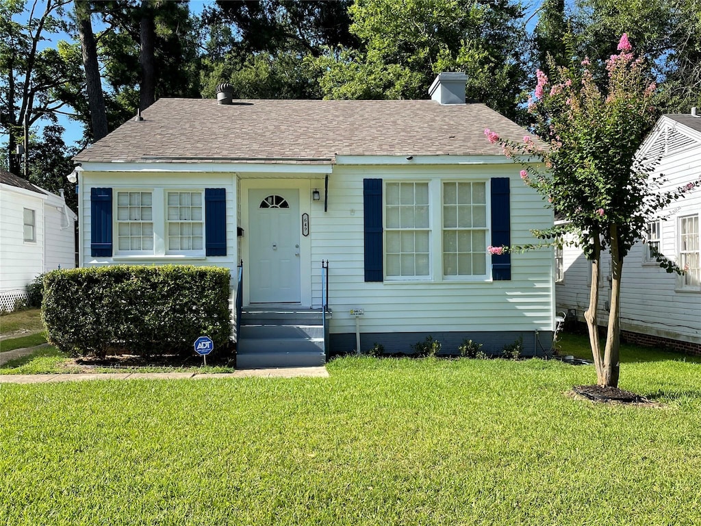 649 College St, Shreveport, LA 71104 - bungalow-style house with a front lawn, a chimney, and a shingled roof