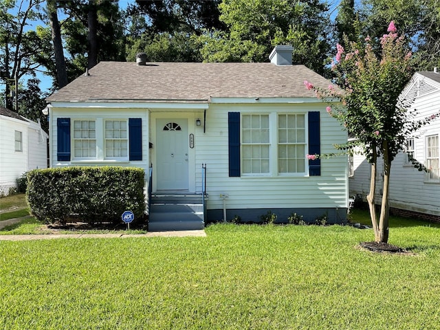 649 College St, Shreveport, LA 71104 - bungalow-style house with a front lawn, a chimney, and a shingled roof