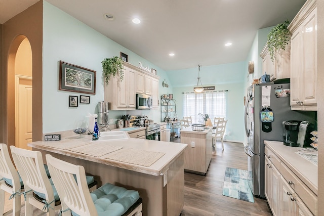 2516 Rushing Springs Dr, Fort Worth, TX 76118 - kitchen featuring appliances with stainless steel finishes, a center island, a sink, wood finished floors, and light countertops