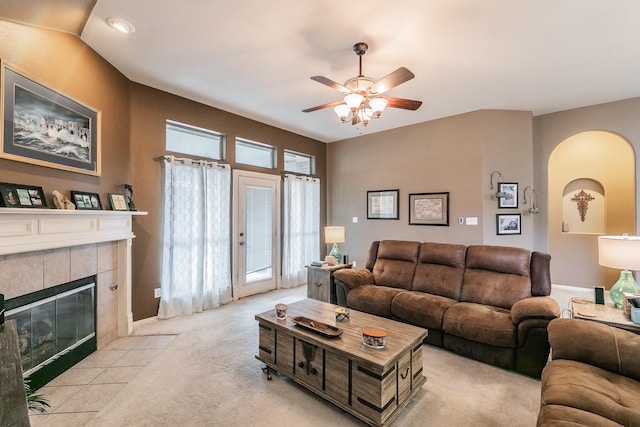 2516 Rushing Springs Dr, Fort Worth, TX 76118 - living room with a ceiling fan, arched walkways, a tile fireplace, carpet floors, and baseboards
