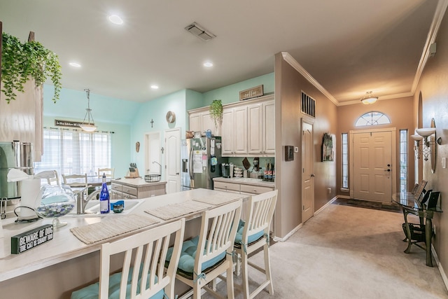 2516 Rushing Springs Dr, Fort Worth, TX 76118 - kitchen featuring stainless steel fridge with ice dispenser, light carpet, light countertops, healthy amount of natural light, and recessed lighting