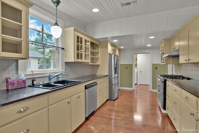 350 Albany Ave, Shreveport, LA 71105 - kitchen featuring appliances with stainless steel finishes, a sink, cream cabinetry, under cabinet range hood, and dark countertops