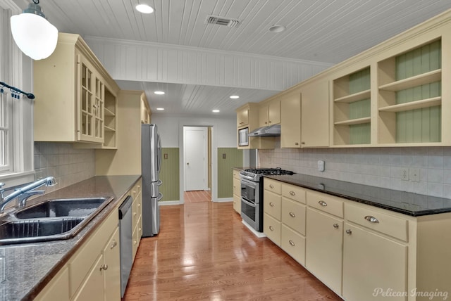350 Albany Ave, Shreveport, LA 71105 - kitchen with cream cabinetry, appliances with stainless steel finishes, a sink, under cabinet range hood, and open shelves