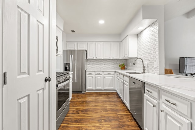3212 Santana Ln, Plano, TX 75023 - kitchen featuring a sink, stainless steel appliances, white cabinets, dark wood-type flooring, and light stone countertops