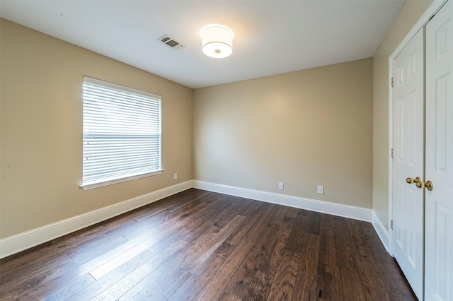 2231 Templeton Dr, Arlington, TX 76006 - unfurnished bedroom with a closet, dark wood-style floors, and baseboards