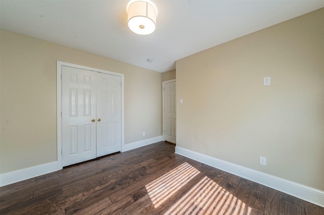 2231 Templeton Dr, Arlington, TX 76006 - unfurnished bedroom with dark wood-style floors, baseboards, and a closet