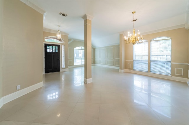 2231 Templeton Dr, Arlington, TX 76006 - foyer entrance with a chandelier, crown molding, healthy amount of natural light, light tile patterned floors, and decorative columns