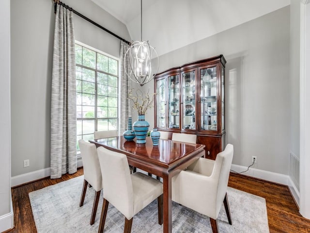 11483 Mirage Ln, Frisco, TX 75033 - dining space featuring a chandelier, baseboards, wood finished floors, and lofted ceiling
