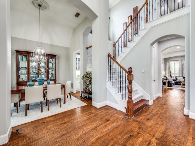 11483 Mirage Ln, Frisco, TX 75033 - entryway with a high ceiling, arched walkways, wood finished floors, stairway, and baseboards