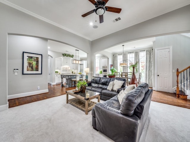 11483 Mirage Ln, Frisco, TX 75033 - carpeted living room featuring arched walkways, ceiling fan, stairway, a chandelier, and baseboards